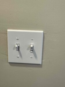 Deshaies Electrical Services installing light switches as part of the electrical load side installation and inspection project