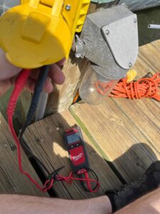 Deshaies Electrical Services testing voltage for pier electrical wiring installation