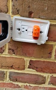 Deshaies Electrical Services troubleshooting and repairing an outdoor electrical outlet